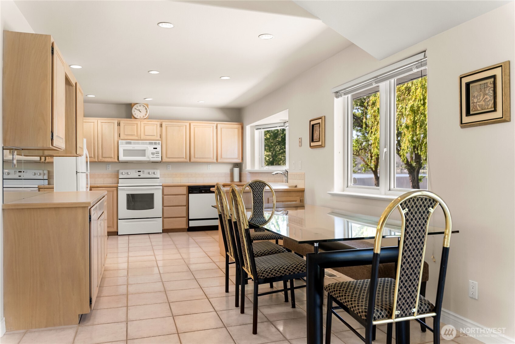 428 Eastlake Road Oroville, WA 98844 - Photo 25 of 34 a kitchen with stainless steel appliances granite countertop a table chairs and a refrigerator