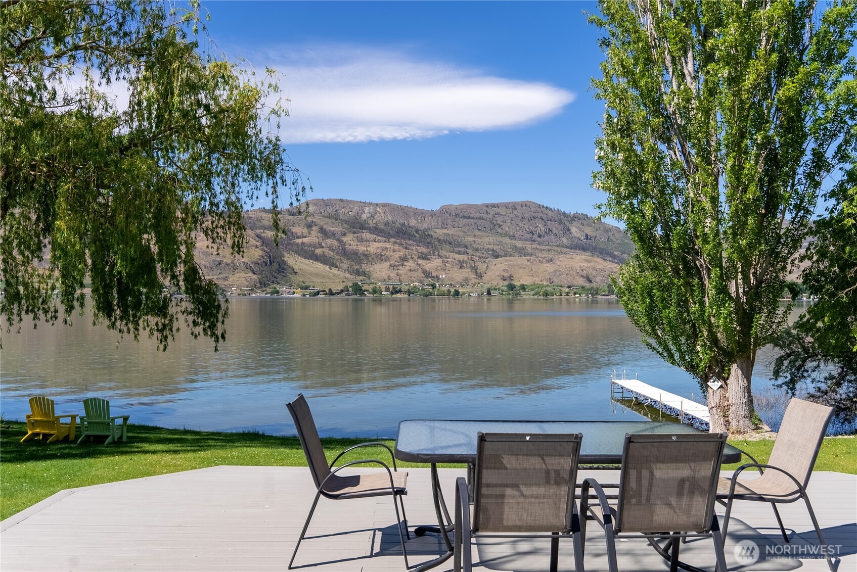 428 Eastlake Road Oroville, WA 98844 - Photo 31 of 34 a view of a lake with table and chairs under an umbrella