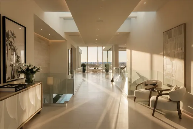 a lobby with furniture and floor to ceiling window