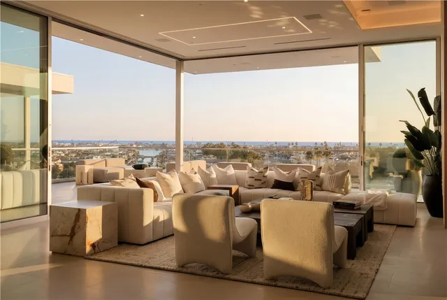 a living room with couches and a coffee table with outer view