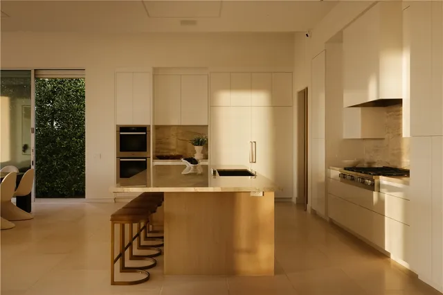 a kitchen with stainless steel appliances a stove a refrigerator and a cabinets