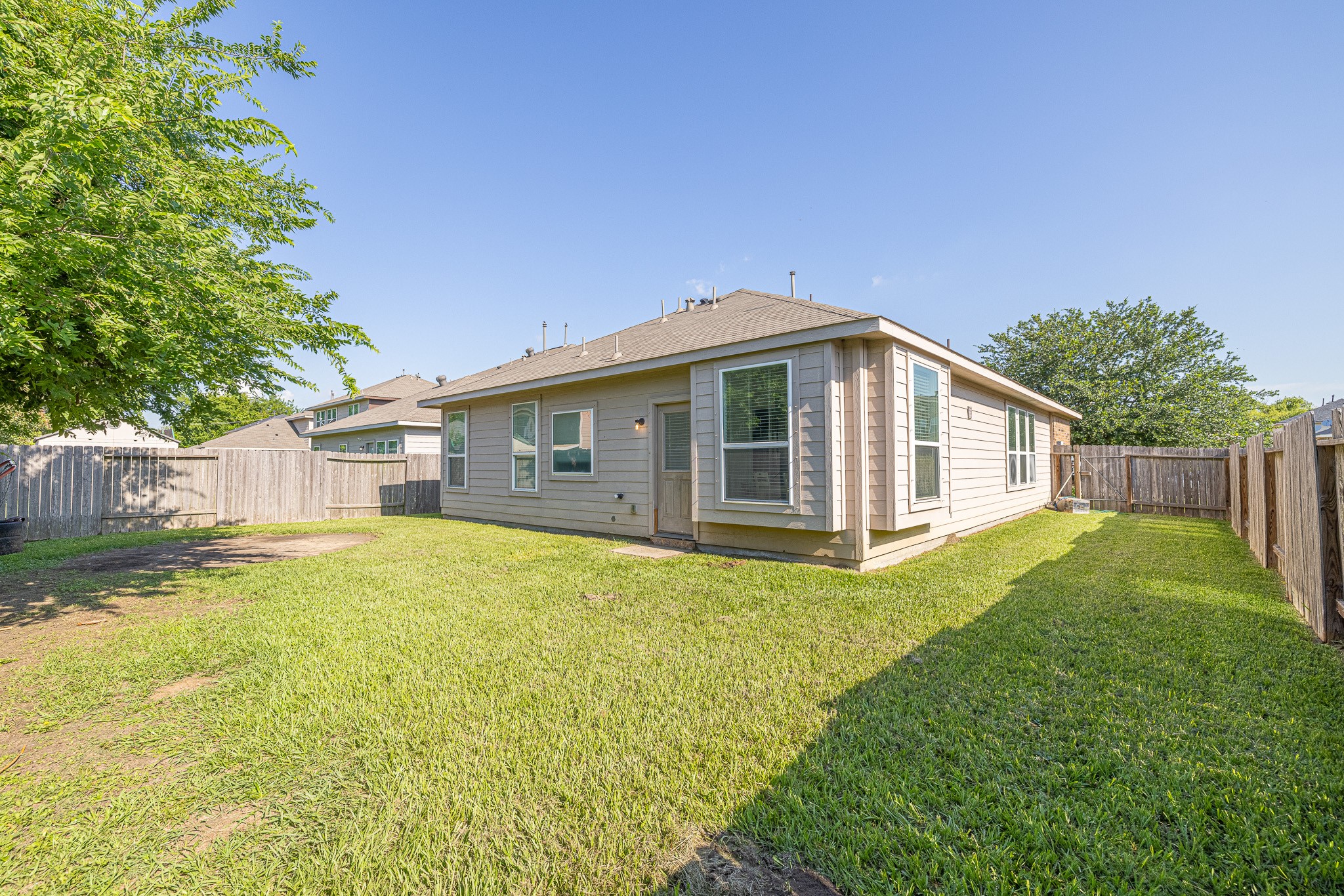 3818 Hunters Trail Baytown, TX 77521 - Photo 28 of 32 a front view of house with yard and trees in the background
