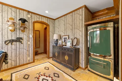 a view of a hallway with wooden floor and door