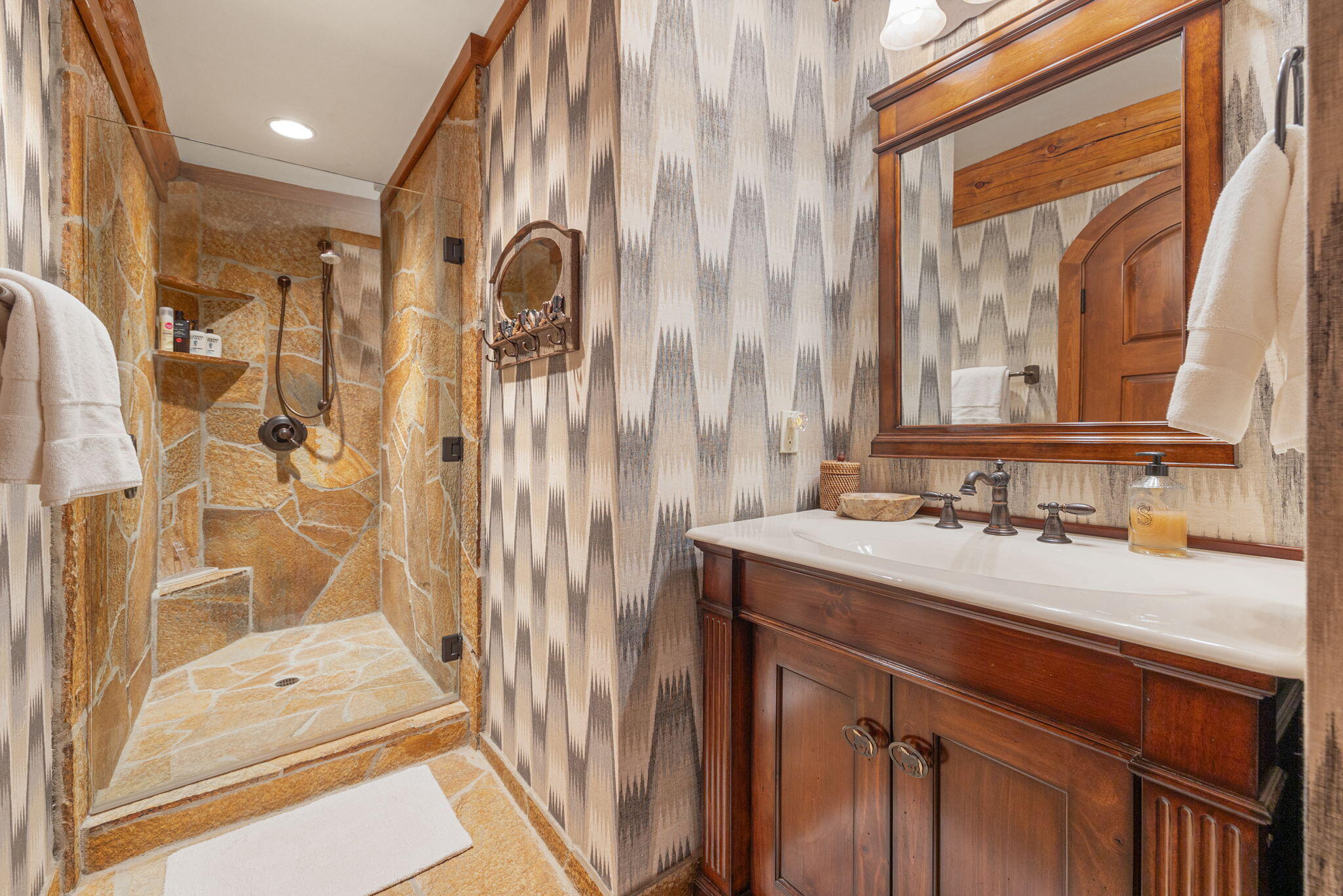 61380 Devils Ladder Road Mountain Center, CA 92561 - Photo 24 of 44 a bathroom with a sink a mirror and a shower