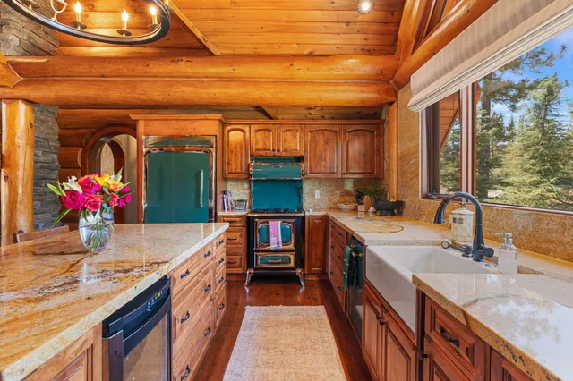 a kitchen with granite countertop lots of counter top space and wooden floor