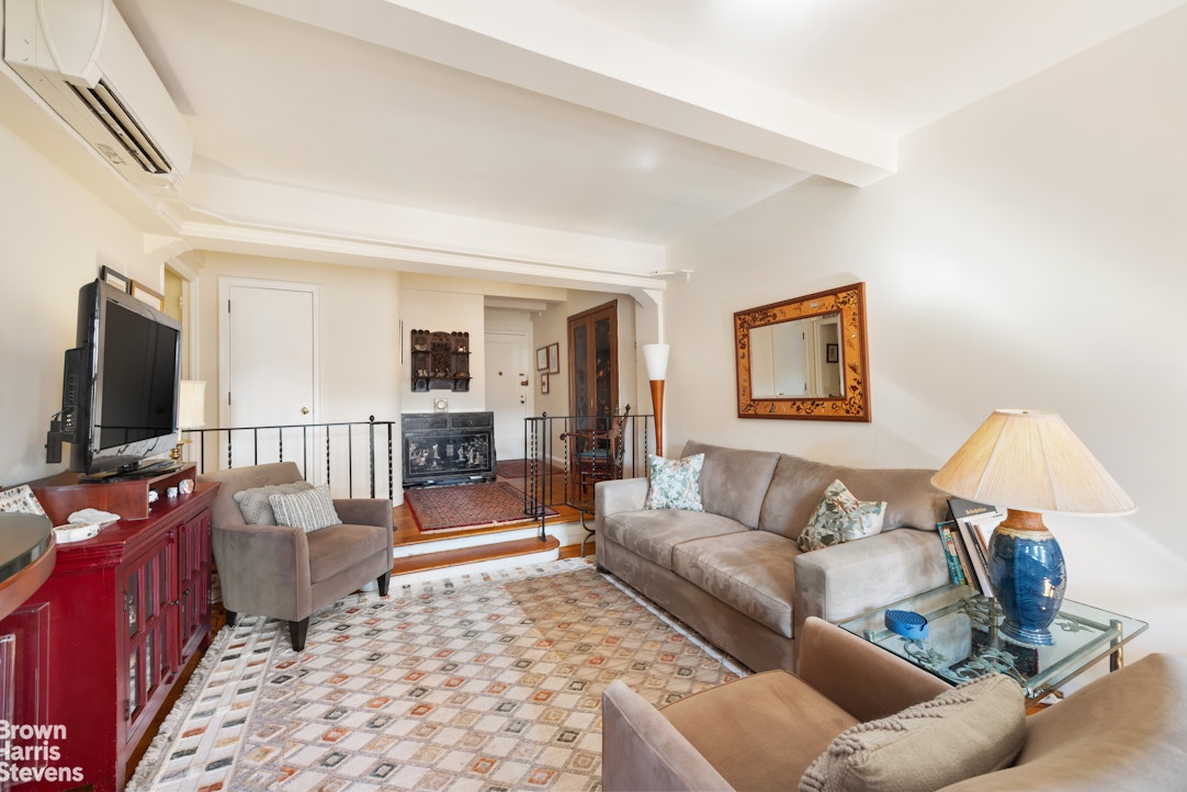 123 East 37th Street, Unit 14C Manhattan, NY 10016 - Photo 5 of 14 a living room with furniture and a flat screen tv