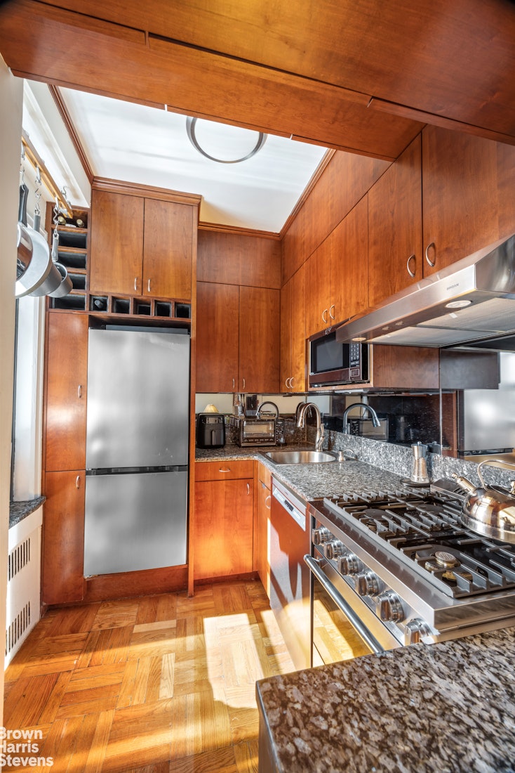 123 East 37th Street, Unit 14C Manhattan, NY 10016 - Photo 6 of 14 a kitchen with stainless steel appliances granite countertop a refrigerator a stove and a sink