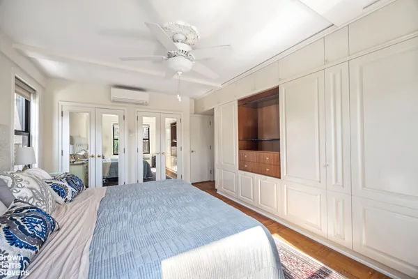 a bedroom with a large bed and a window