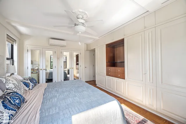 a bedroom with a large bed and a window