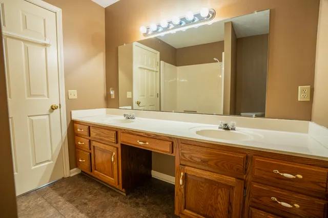 a bathroom with a double vanity sink and a mirror