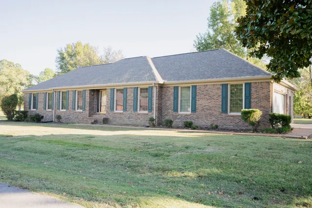a front view of a house with a yard and porch