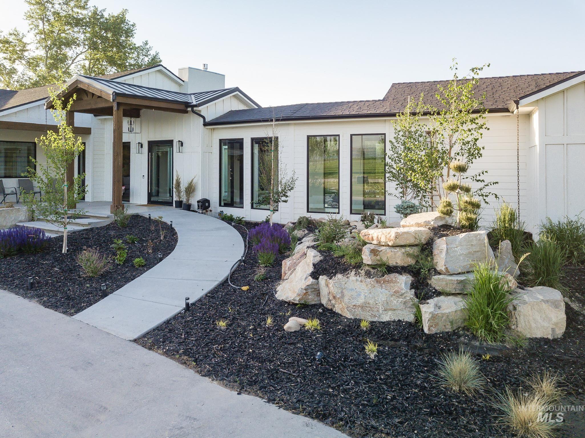 2475 River Ranch Emmett, ID 83617 - Photo 12 of 15 Doorway to property with a standing seam roof, board and batten siding, roof with shingles, and a porch