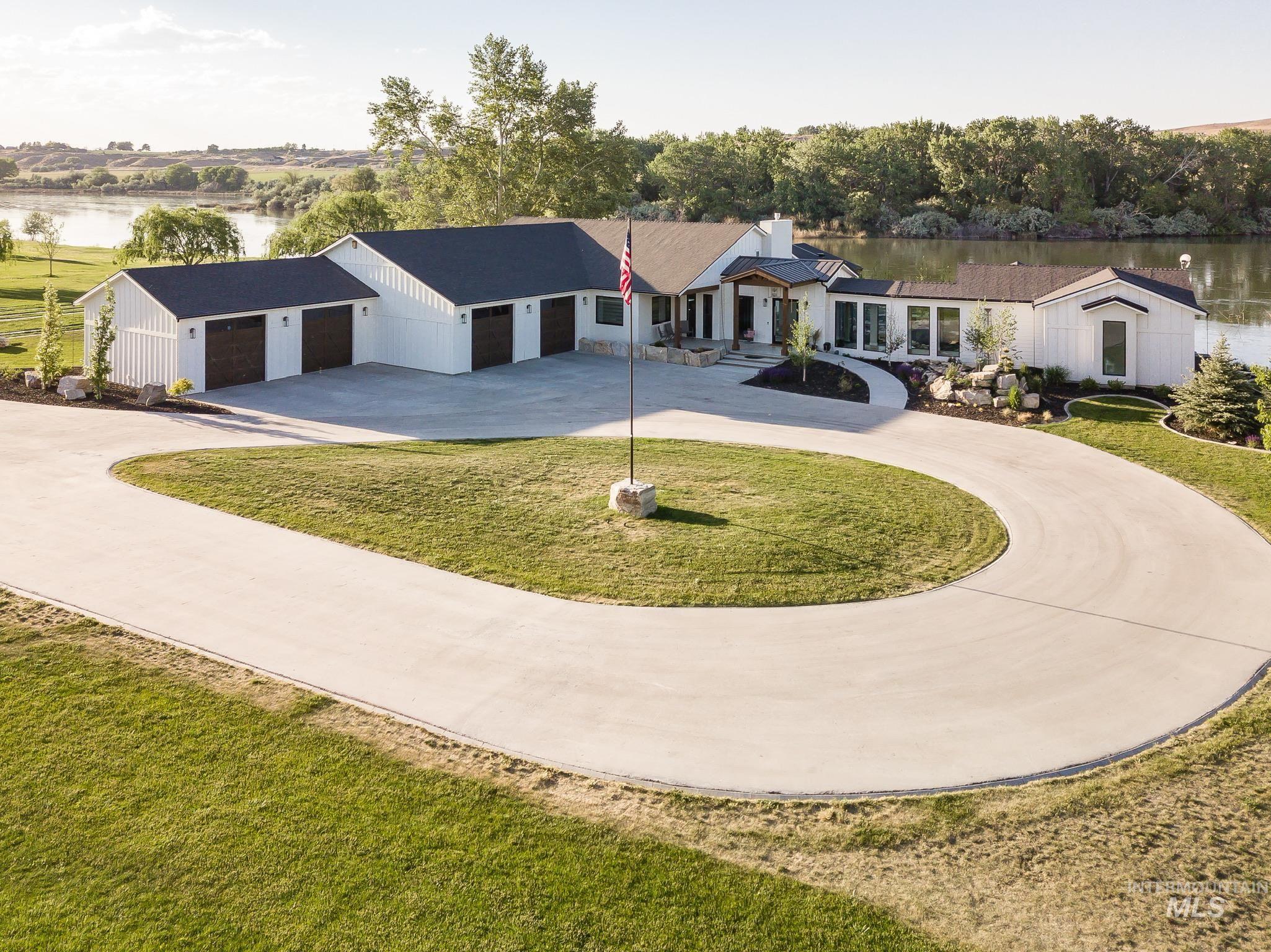 2475 River Ranch Emmett, ID 83617 - Photo 7 of 15 View of front of house featuring a water view, curved driveway, and a front yard