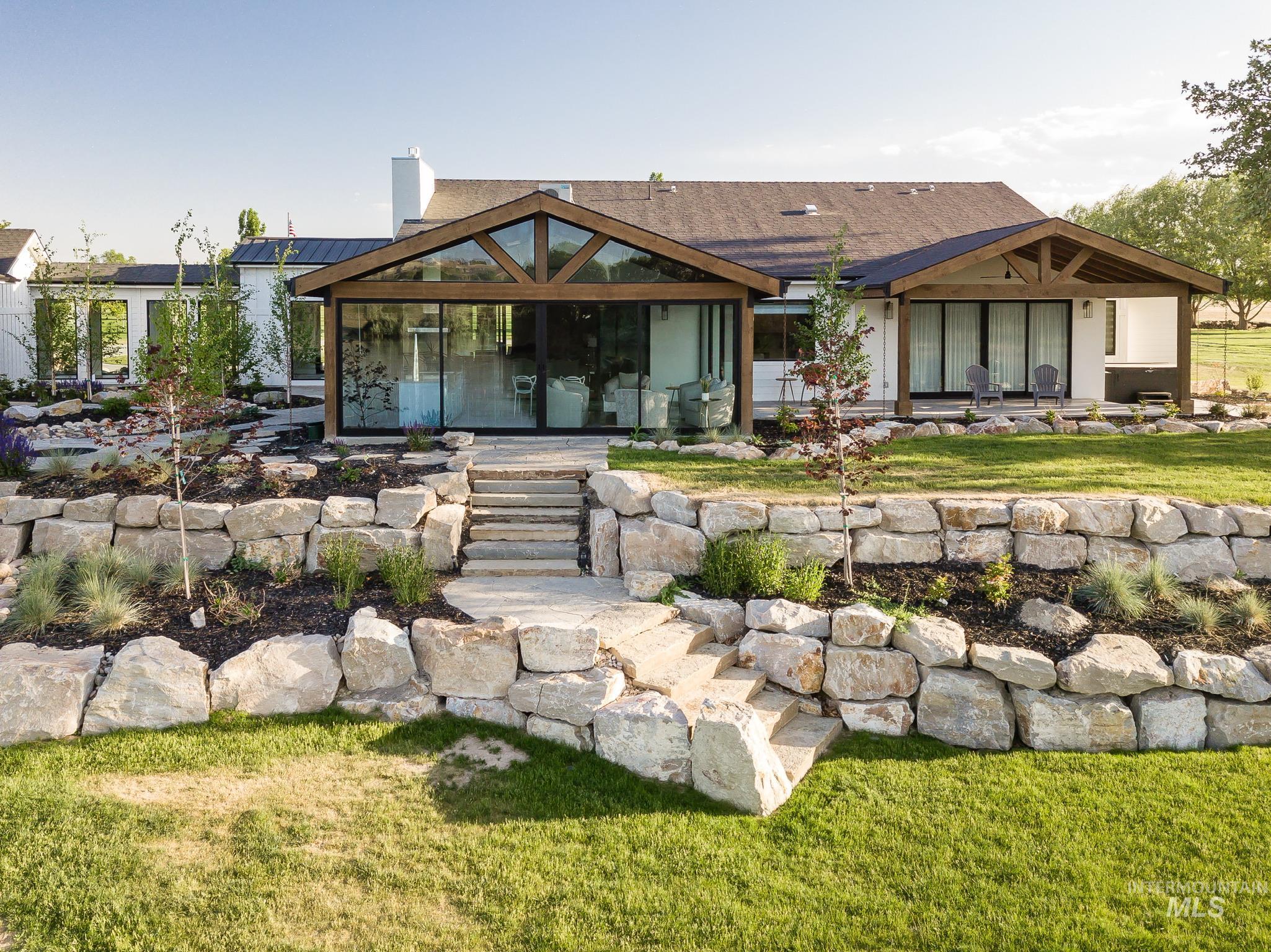 2475 River Ranch Emmett, ID 83617 - Photo 8 of 15 Rear view of house with a patio area, a chimney, and a lawn