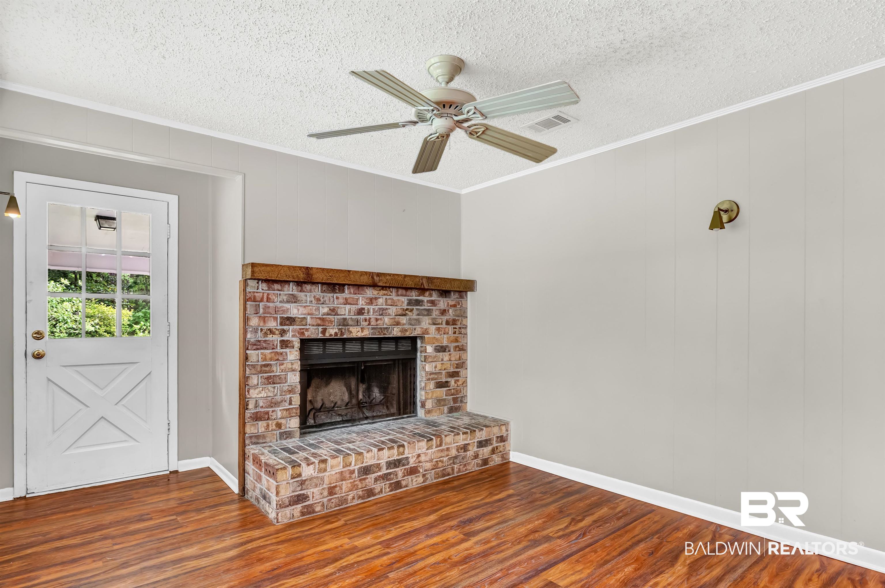 28 Caisson Trace Spanish Fort, AL 36527 - Photo 14 of 51 Den features wood finished floors, a fireplace, a textured ceiling, and crown molding