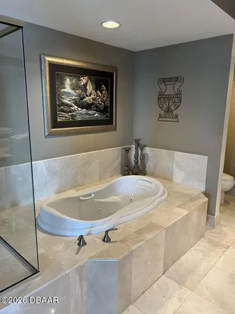 a bathroom with a tub and a shower