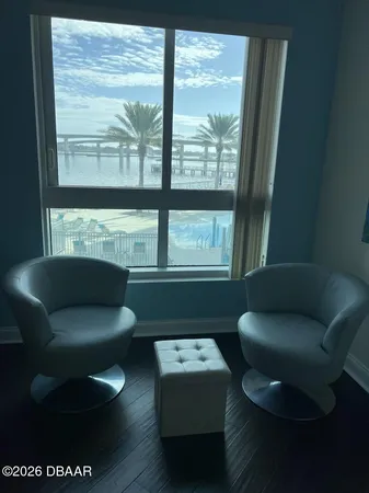 a view of a livingroom with furniture and a large window