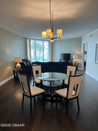 a dining room with furniture and wooden floor