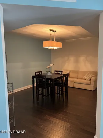 a view of a dining room with furniture and wooden floor