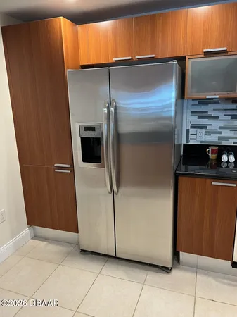 a view of an empty room with wooden floor and a cabinet