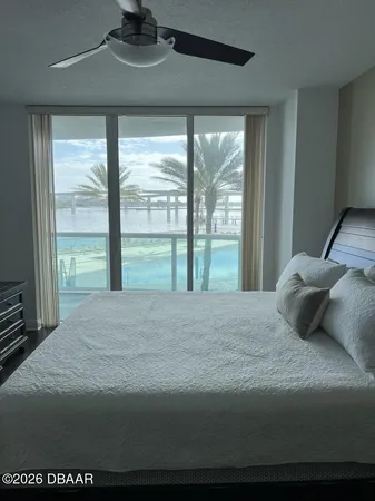 a bedroom with a large bed and a large window