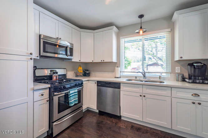 894 Appleton Road Simi Valley, CA 93065 - Photo 8 of 32 a kitchen with stainless steel appliances granite countertop a sink stove a microwave and cabinets