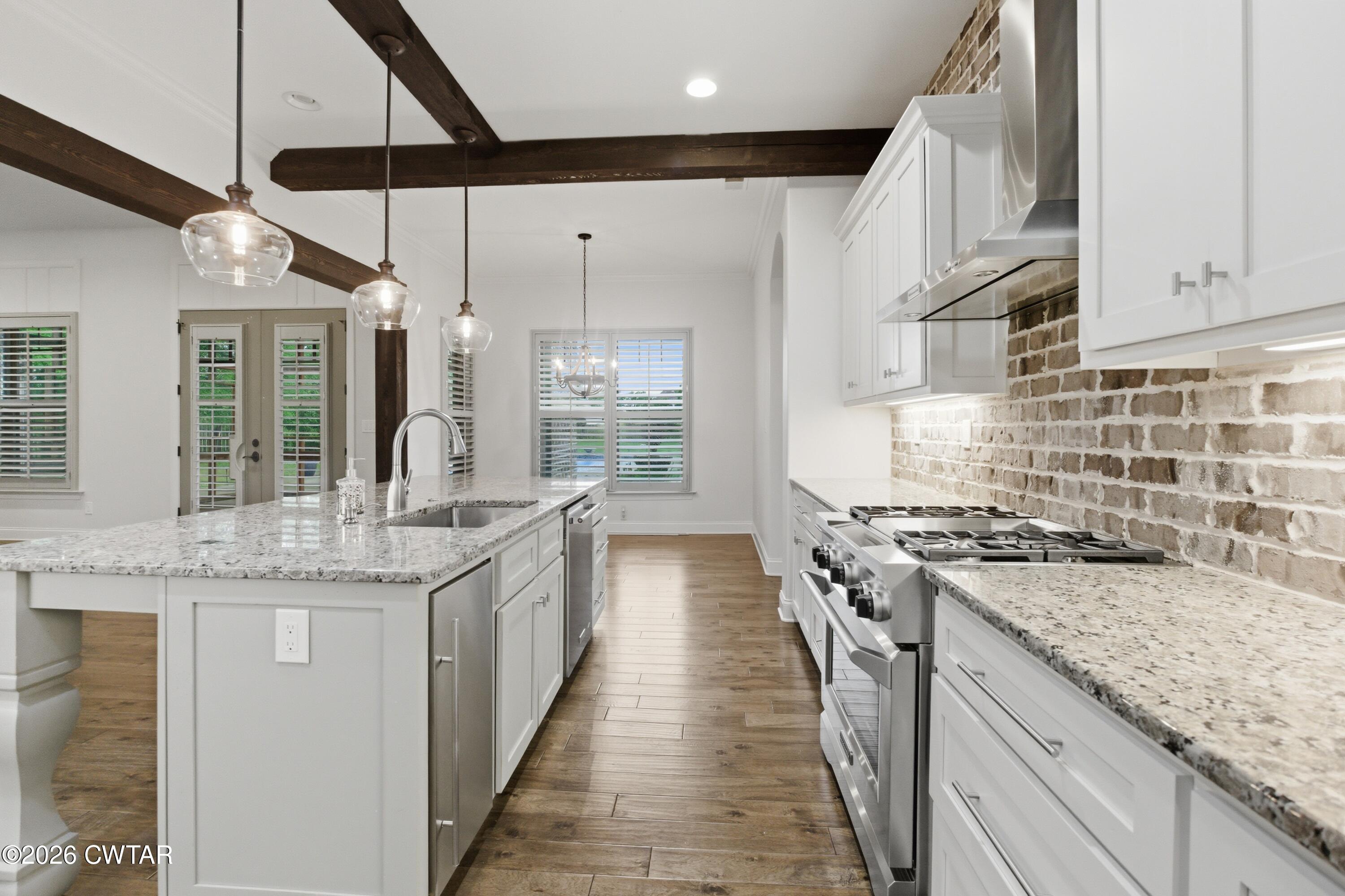 963 Ashport Road Jackson, TN 38305 - Photo 15 of 60 a kitchen with stainless steel appliances granite countertop a stove and a sink