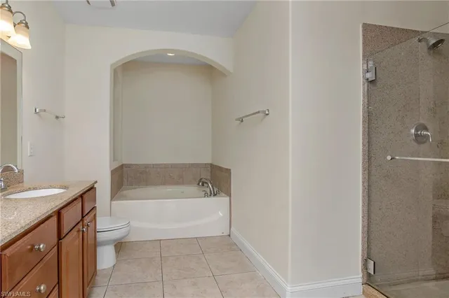 a bathroom with a bathtub a sink a toilet and a shower