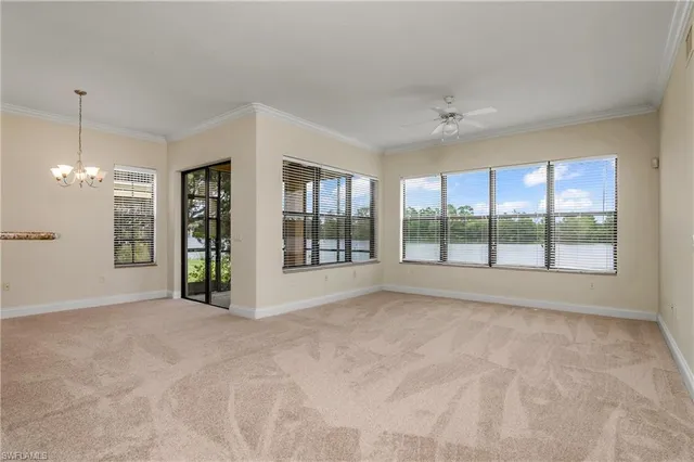 a view of an empty room with window and cabinet