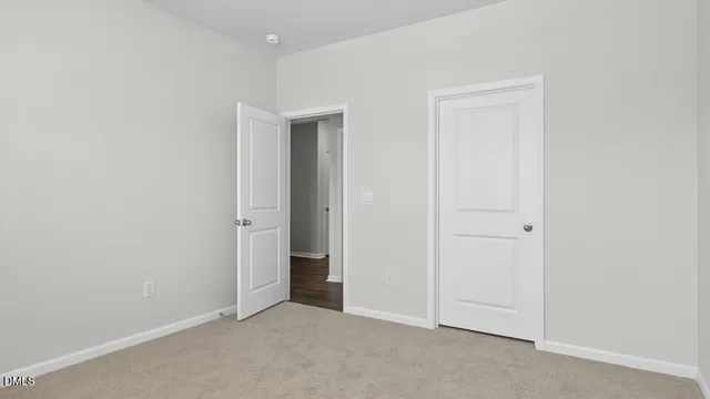 an empty room with closet area