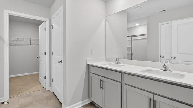 a bathroom with 2 sink and a mirror