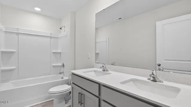 a bathroom with a sink double vanity granite toilet tub and shower