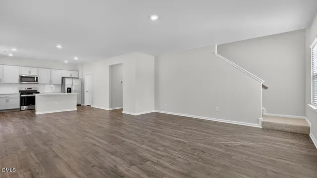 a view of a kitchen with a sink and a refrigerator