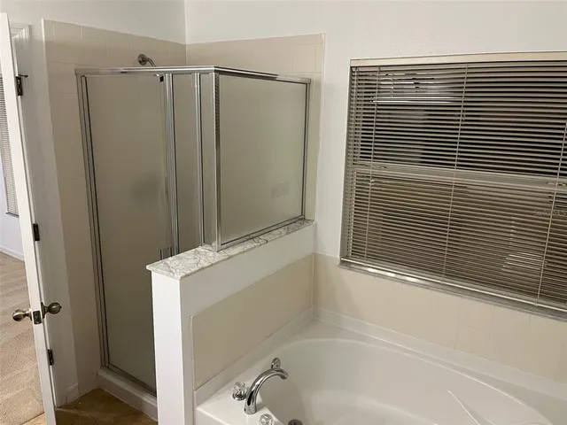 a bathroom with a shower and a sink