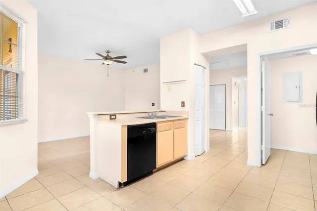a view of a kitchen with cabinets and stainless steel appliances