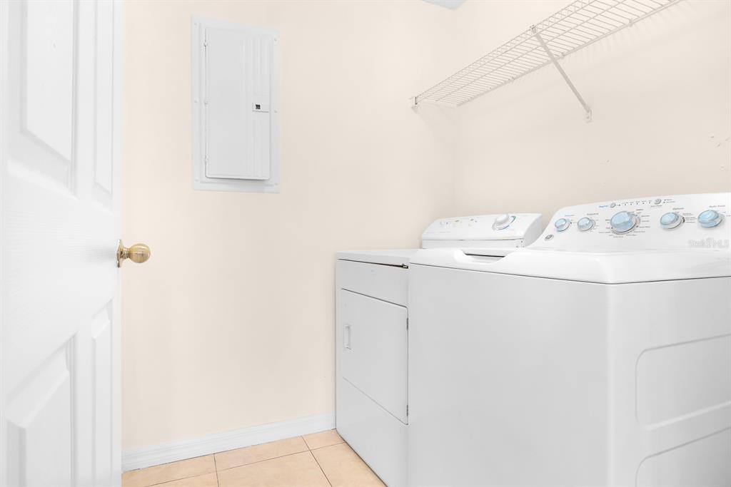 10873 Windsor Walk Drive, Unit 4106 Orlando, FL 32837 - Photo 12 of 30 a utility room with dryer and washer