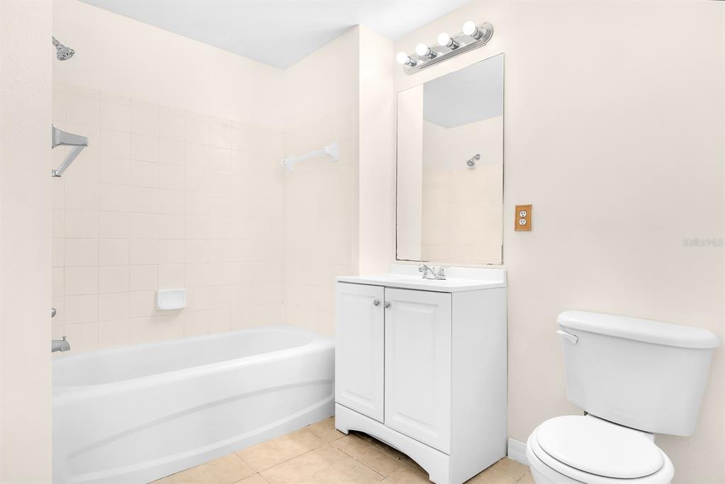 10873 Windsor Walk Drive, Unit 4106 Orlando, FL 32837 - Photo 19 of 30 a bathroom with a sink a toilet and shower