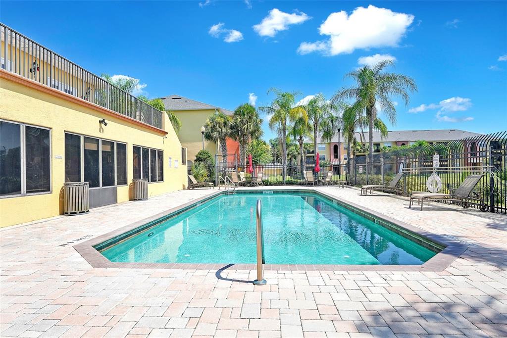 10873 Windsor Walk Drive, Unit 4106 Orlando, FL 32837 - Photo 25 of 30 a swimming pool with outdoor seating
