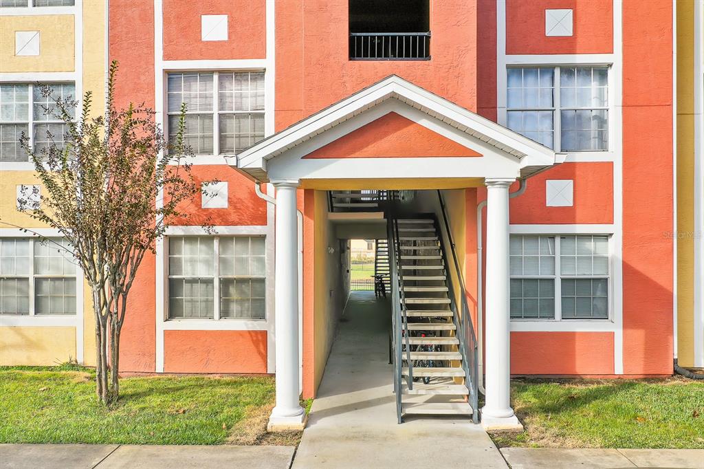 10873 Windsor Walk Drive, Unit 4106 Orlando, FL 32837 - Photo 26 of 30 a front view of a house with a yard and garage