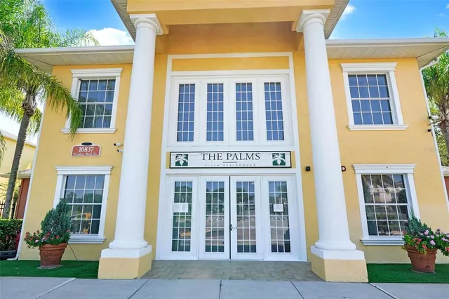 a view of a swimming pool with a bench and trees