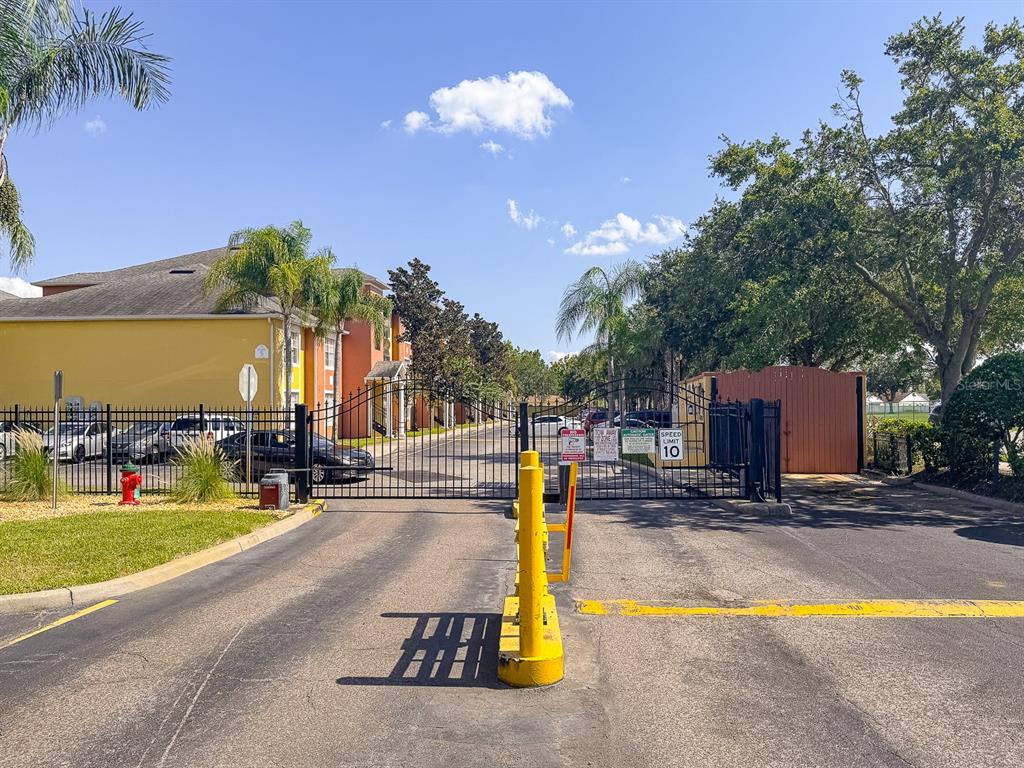 10873 Windsor Walk Drive, Unit 4106 Orlando, FL 32837 - Photo 28 of 30 a view of a swimming pool with a bench and trees