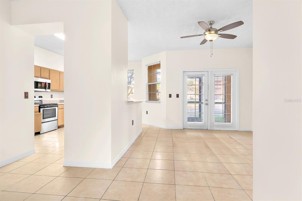 10873 Windsor Walk Drive, Unit 4106 Orlando, FL 32837 - Photo 5 of 30 a view of a kitchen with furniture and an empty room
