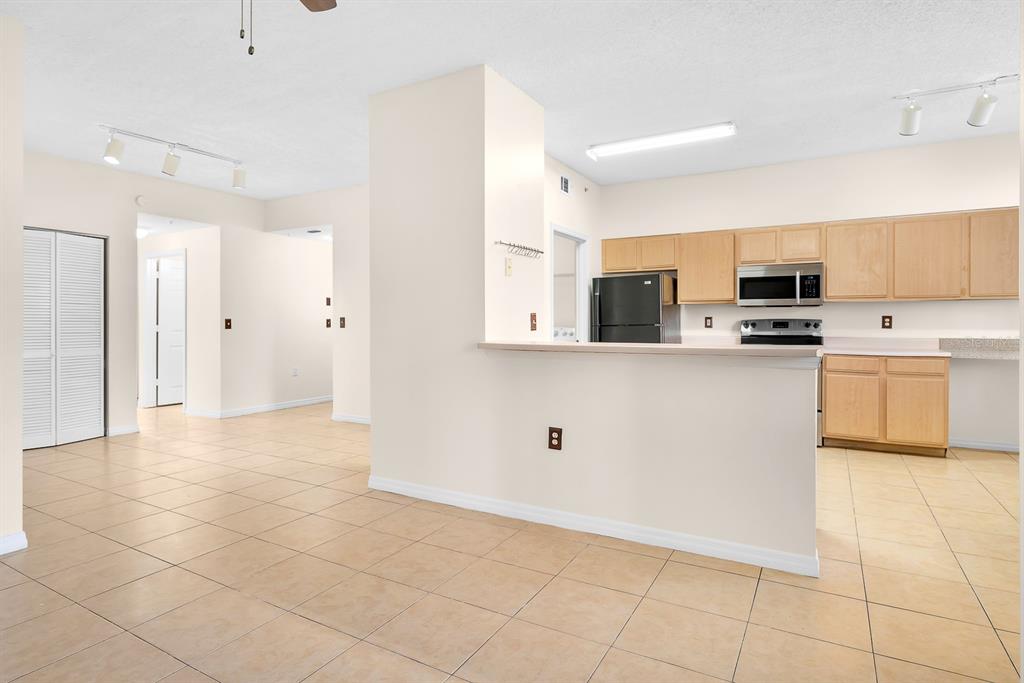 10873 Windsor Walk Drive, Unit 4106 Orlando, FL 32837 - Photo 7 of 30 a view of a kitchen with electric appliances