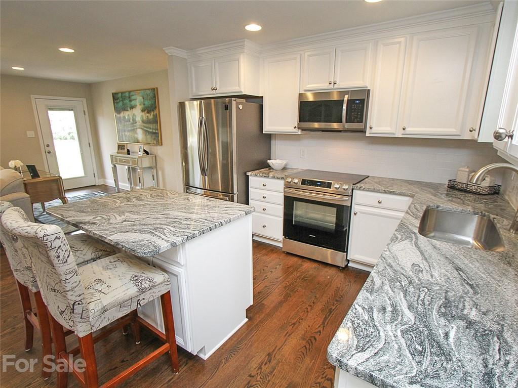 405 Fieldstone Road Mooresville, NC 28115 - Photo 2 of 46 a kitchen with stainless steel appliances granite countertop a stove refrigerator sink and microwave