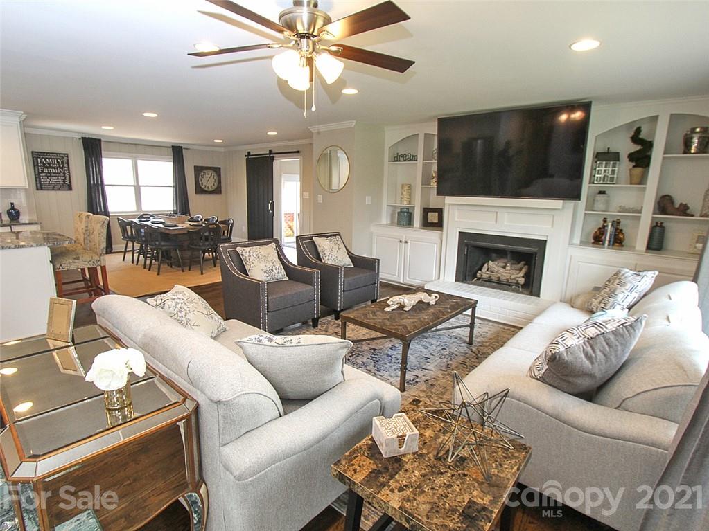405 Fieldstone Road Mooresville, NC 28115 - Photo 11 of 46 a living room with furniture a fireplace and a flat screen tv
