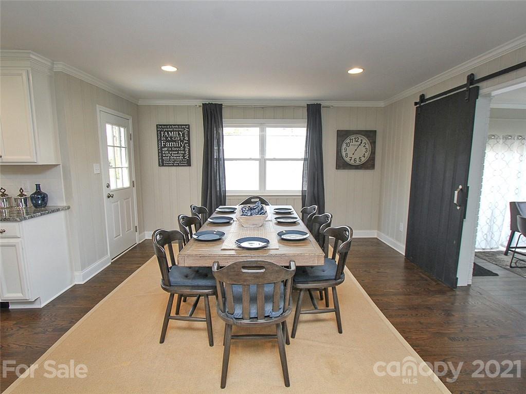 405 Fieldstone Road Mooresville, NC 28115 - Photo 15 of 46 a view of a dining room with furniture window and wooden floor