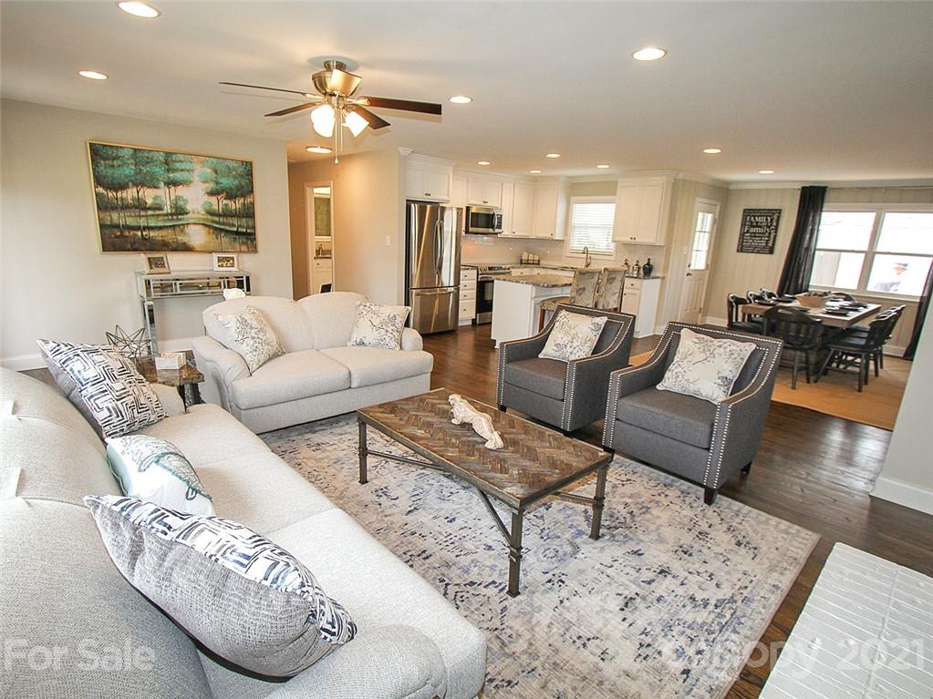 405 Fieldstone Road Mooresville, NC 28115 - Photo 19 of 46 a living room with furniture kitchen view and a wooden floor
