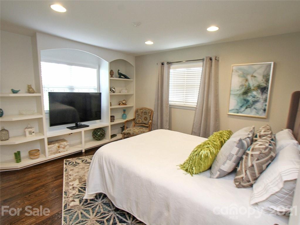 405 Fieldstone Road Mooresville, NC 28115 - Photo 28 of 46 a bedroom with a bed and a flat tv screen on dresser