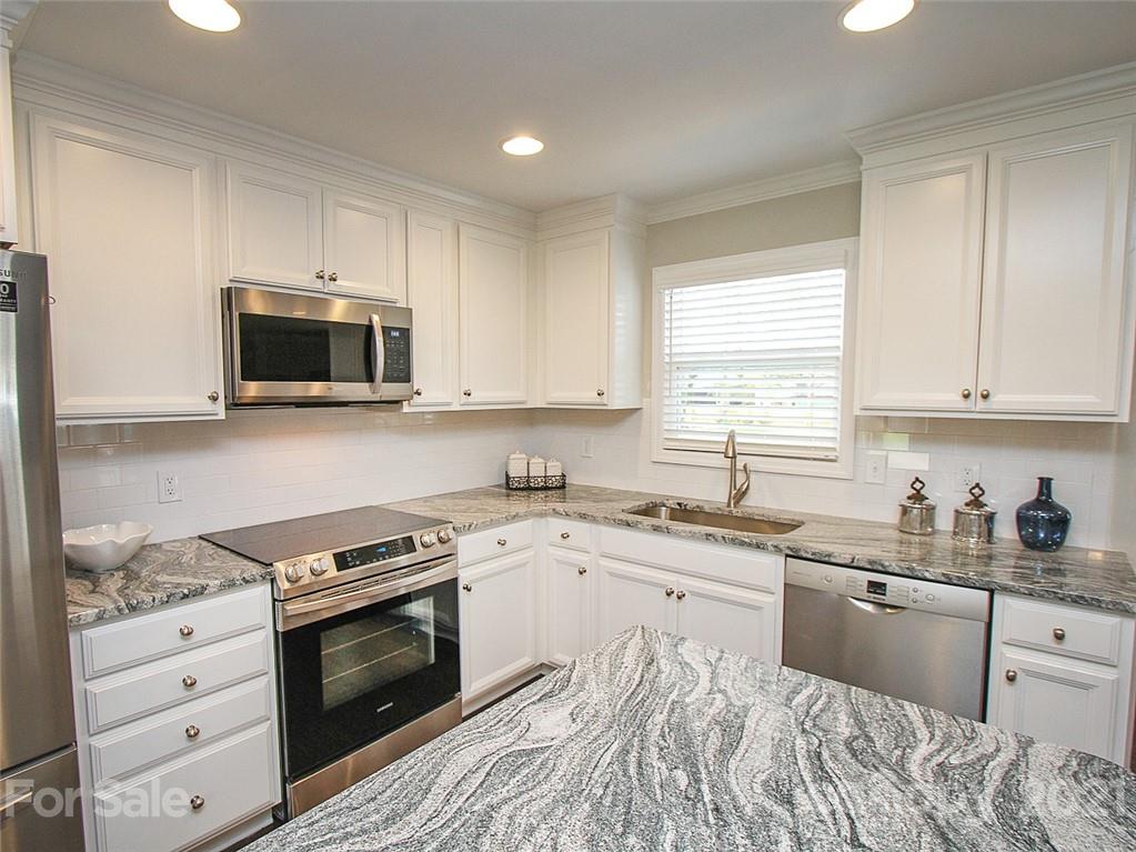 405 Fieldstone Road Mooresville, NC 28115 - Photo 4 of 46 a kitchen with a sink stove and microwave