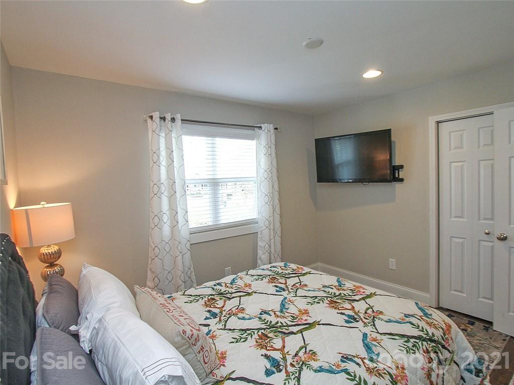 405 Fieldstone Road Mooresville, NC 28115 - Photo 34 of 46 a bedroom with a bed and a flat screen tv